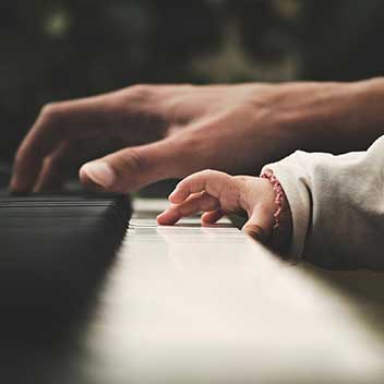 parent and child at piano